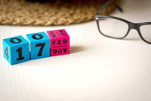 modern perpetual calendar composed of colored cubes and set at the date of February 17th