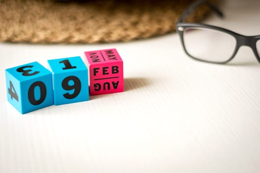 modern perpetual calendar composed of colored cubes and set at the date of February 9th