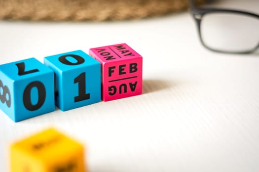 modern perpetual calendar composed of colored cubes and set at the date of February 1st