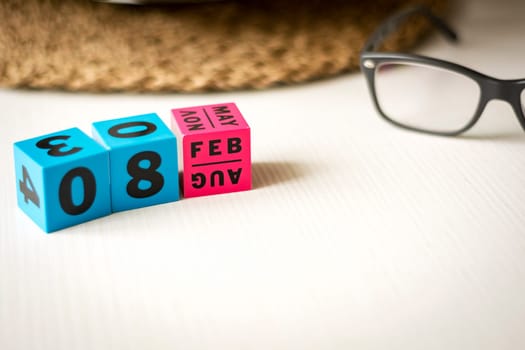 modern perpetual calendar composed of colored cubes and set at the date of February 8th