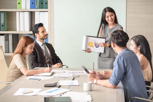 professional businesswoman present financial chart with team in the meeting