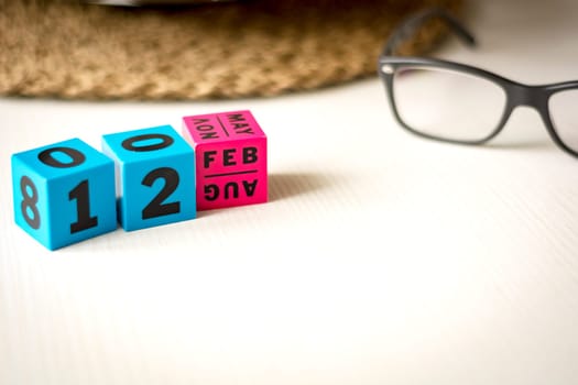 modern perpetual calendar composed of colored cubes and set at the date of February 12th