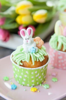 Small colorfully decorated cupcake for Easter