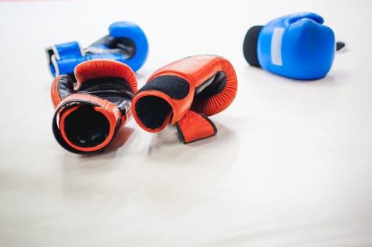 Boxing red and blue gloves Lie on white floor of ring