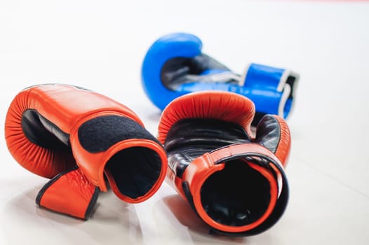 Boxing red and blue gloves Lie on white floor of ring