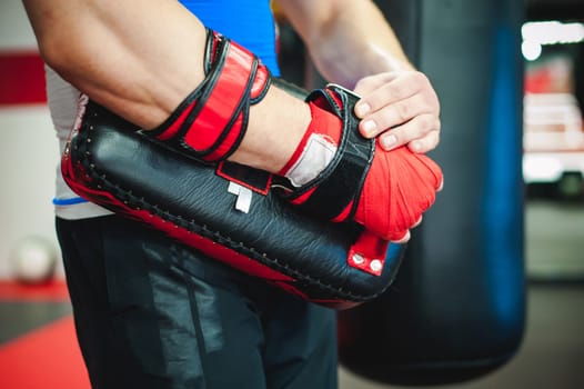 Professional fighter coach puts on boxing paws