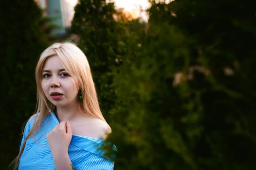 portrait of a cute young blond woman with a summer day