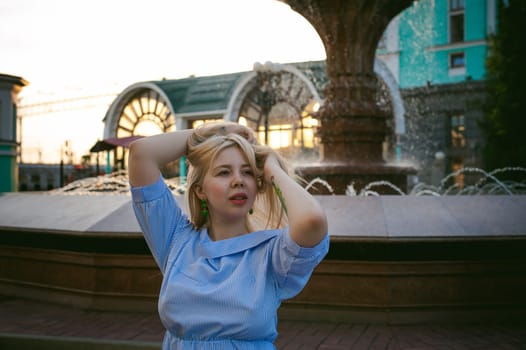 portrait of a cute young blond woman with a summer day