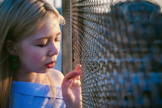 portrait of a cute young blond woman with a summer day