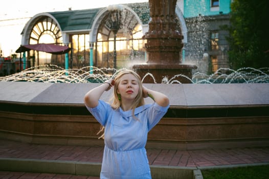 portrait of a cute young blond woman with a summer day