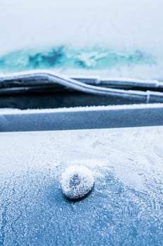 Iceflowers, frozen.The ice-cold frost forms ice crystals in beautiful unique patterns on the window, Hood and wiper on the Car
