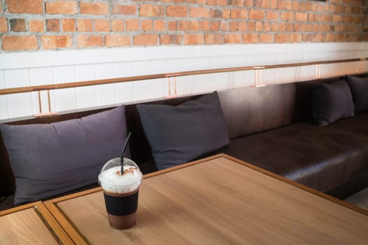 Iced milk froth coffee serving on wooden table, stock photo