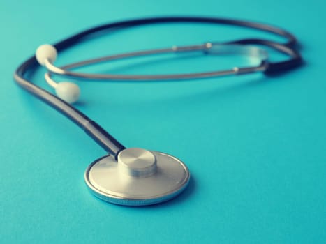 Stethoscope on a blue background, heath care or medical concept background
