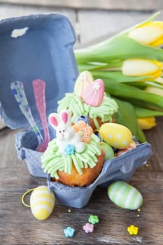 Small colorfully decorated cupcake for Easter