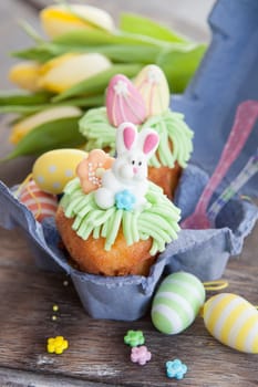Small colorfully decorated cupcake for Easter