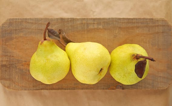Three pears on a piece of weathered wood with room for text