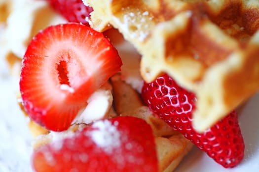 Closeup of strawberries and cream cheese between waffles