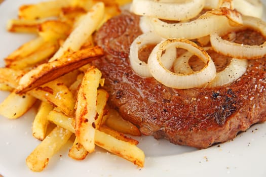 Steak with sauteed onions and french fries