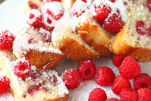 Raspberry cake with fresh berries and powdered sugar