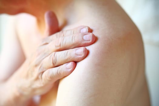 Senior man with shoulder joint pain closeup