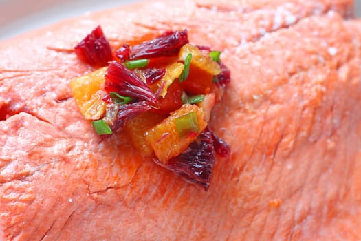 Closeup of roasted salmon with a salsa of blood oranges and scallions