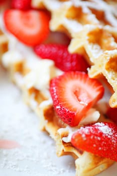 Strawberries and cream cheese between two waffle halves close up