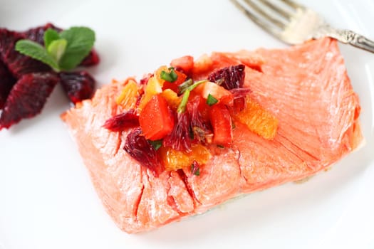 Portion of salmon with a salsa made of tomatoes, scallions and blood oranges