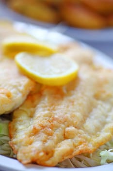 Closeup of fried catfish with lemon slices
