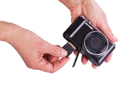 Insert memory card into the camera. Woman's hands on a white background.