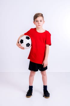 boy in red shirt with soccer ball in front of white background