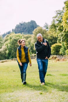 Senior couple are enjoying a walk through the woodlands at the Lake District