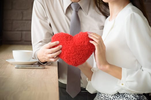 couple love man and woman holding red heart, love and valentine concept