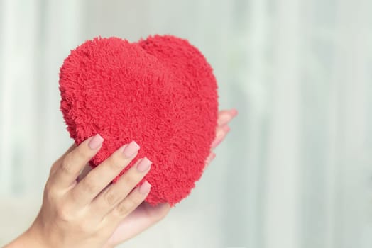 woman hand holding romantic red heart, love and valentine concept, copy space