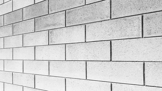 Beautiful brick wall blocks. Wall light brick walls of the unusual wide perspective for background.