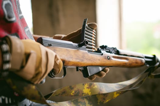 rifle carbine is weapon in hands. closeup tactical gloves  weapons, reloading ammunition. Soldier on a position performing a combat mission