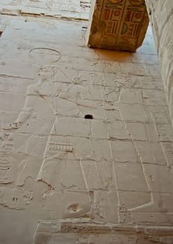 Egyptian relief carved wall and painting hieroglyphs on ceiling in Karnak temple, Egypt