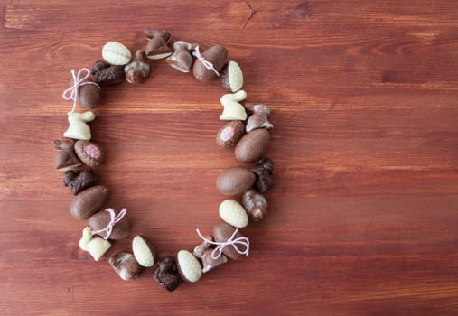 Various chocolates and Easter eggs at Easter on a wooden background
