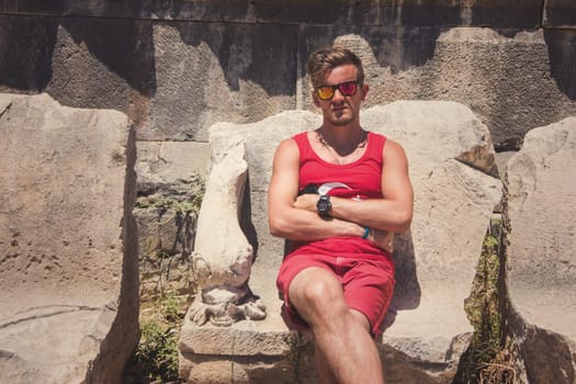 Young man at theatre in Myra ancient city of Antalya in Turkey.