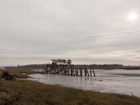 wooden sea structure moody overcast grey sky river estuary  essex  england  uk