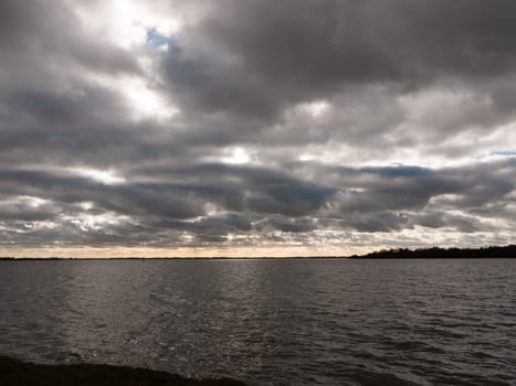 moody sky overcast autumn winter bay water ocean trees  essex  england  uk