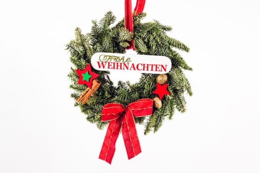 Christmas wreath made of fir branches exposed on a white background