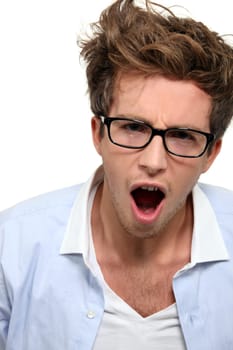 Man in glasses yawning