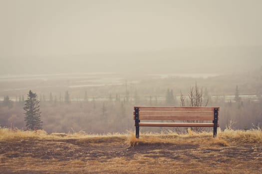 Bench looking over a misty landscape