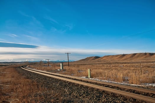 Curvy train tracks in the prairie.
