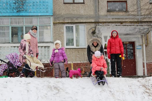 town and joy children are sleding from the hill