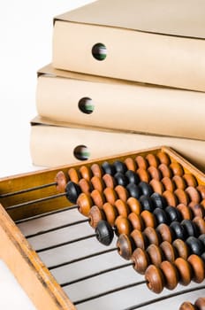Old abacus and folders with documents, close-up