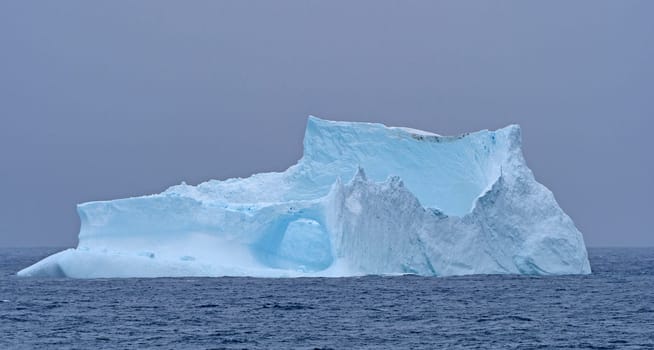 Iceberg Coming out of the Fog near Baffin Island in Nunavut, Canada