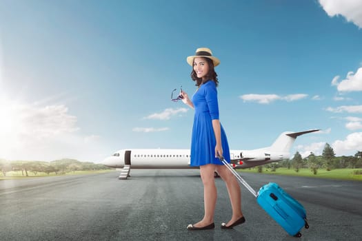 Attractive asian woman going vacation with airplane over blue sky background