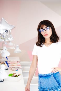 Portrait of a beautiful woman with pink lips in glasses.