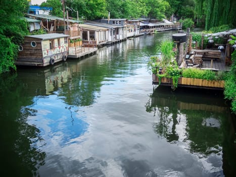 Berlin,Germany - August 11,2016: Wooden houses as an art,scene and party meeting place of the flutgraben in Berlin-Kreuzberg in summer.